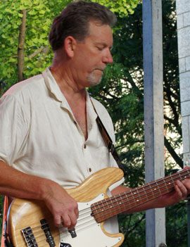 Photo of Greg playing guitar